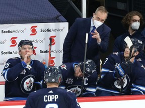 Winnipeg Jets head coach Paul Maurice (top) has a word for Adam Lowry during a break in NHL action against the Ottawa Senators in Winnipeg on Mon., April 5, 2021.