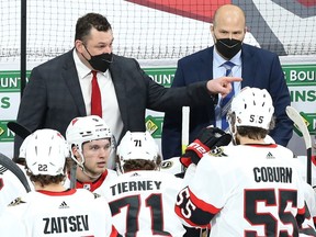 Ottawa Senators head coach D.J. Smith (left) directs his troops during a break in NHL action against the Winnipeg Jets in Winnipeg on April 5, 2021.
