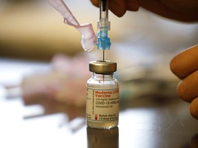 Nurse Brenda Lotakoun draws a dose of the Moderna COVID-19 vaccine March 23 in Toronto. Cole Burston/Getty Images