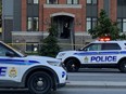 Ottawa Police Service cruisers at the scene of reported stabbings on Baseline Road on Tuesday evening.