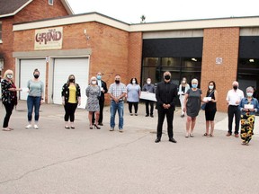 Ottawa's Marty Koch (black suit in front) recently donated $5,000 to each of six Pembroke organizations after winning $1.4 million in a CHEO lottery earlier this year.