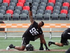 A 2018 file photo shows defensive lineman Danny Mason warming up before a Redblacks practice at TD Place stadium. He's now working as a personal trainer in Texas.
