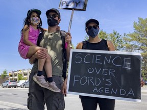 Maxime and Sarah Bedard with 5 year old daughter Eva took part in a school closures protest near the office of Nepean MPP Lisa MacLeod.  Thursday, Jun. 10.