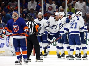Lightning forward Brayden Point (21) is congratulated by his teammates after scoring a goal as Islanders defenceman Andy Greene (left) reacts during the second period in Game 3 of the Stanley Cup Semifinals at Nassau Coliseum in Uniondale, N.Y., Thursday, June 17, 2021.