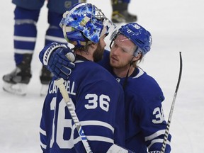 Maple Leafs goalie Jack Campbell is consoled by defenceman Rasmus Sandin after losing to the Canadiens in Game 7 of the first round of the 2021 Stanley Cup Playoffs at Scotiabank Arena in Toronto, Monday, May 31, 2021.
