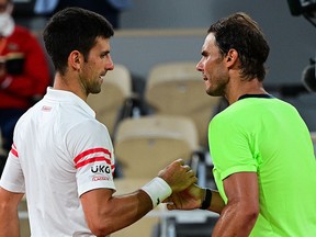 Novak Djokovic (left) and Rafael Nadal shake hands at the end of their men's French Open semifinal in Paris on June 11, 2021.