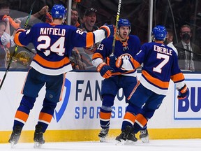 Islanders centre Mathew Barzal (centre) celebrates after scoring a goal against the Bruins during the third period in Game 4 of the second round of the 2021 Stanley Cup Playoffs at Nassau Veterans Memorial Coliseum in Uniondale, N.Y., Saturday, June 5, 2021.