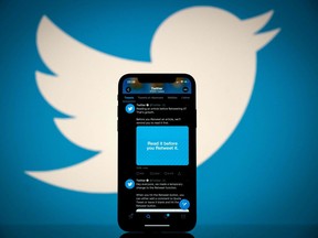 In this file photo taken on Oct. 26, 2020, this photograph shows the logo of U.S. social network Twitter displayed on the screen of a smartphone and a tablet in Toulouse, southern France.