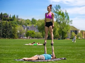 Gillian Moon balances with the help of Elliot Fudge as they enjoyed a sunny warm afternoon in Riley Park