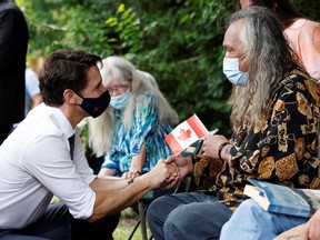 Prime Minister Justin Trudeau speaks to Terry Idlout at Hope Living in Kanata on Wednesday.