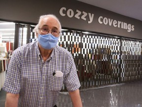 Ted Barkun, owner of Cozzy Coverings, can't open because he doesn't have an exterior door.
