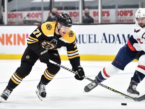 Boston Bruins left wing Taylor Hall controls the puck past Washington Capitals defenceman Justin Schultz during the second period in game four of the first round of the 2021 Stanley Cup Playoffs at TD Garden.