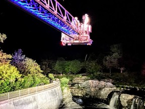 Technicians from Ottawa Fire Services rescue a man in the water at Hog's Back Falls on the night of June 13, 2021.