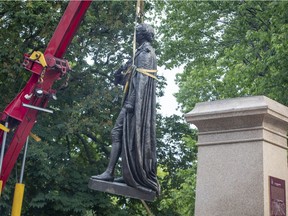 The statue of Sir John A. Macdonald is removed in Kingston on Friday June 18, 2021.