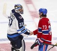 Montreal Canadiens Tyler Toffoli (right) shakes hands with Winnipeg Jets goalie Connor Hellebuyck following his game-winning goal in overtime during Game 4 at the Bell Centre on Monday night.