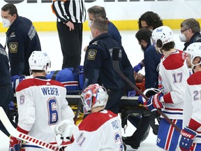 Montreal Canadiens centre Jake Evans is taken off the ice on a stretcher after being hit hard by Winnipeg Jets centre Mark Scheifele late in Game 1 of the North Division final in Winnipeg on Wednesday night.