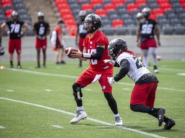 The Ottawa Redblacks returned to the field on Sunday, July 11, 2021, for the club's first practice of this year's training camp. Quarterback Matt Nichols hands the ball off to Timothy Flanders during training camp Sunday.