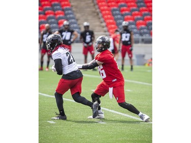 The Ottawa Redblacks returned to the field on Sunday, July 11, 2021, for the club's first practice of this year's training camp. Quarterback Matt Nichols hands the ball off to Timothy Flanders during training camp Sunday.