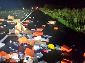 Nike products are strewn over Highway 401 after two big rigs collided early Saturday. There were no injuries.