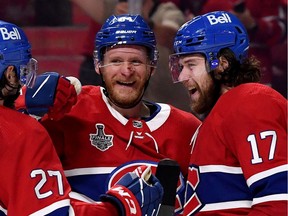 Josh Anderson (No. 17) of the Montreal Canadiens celebrates with Corey Perry after scoring the game-winning overtime goal in Game 4.