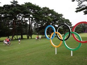 Collin Morikawa, Justin Thomas and Xander Schauffele of Team USA play a practice round at Kasumigaseki Country Club in Tokyo yesterday.