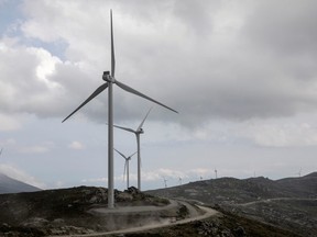 A truck drives along wind turbines on a mountain road near the town of Karystos on the island of Evia, Greece, April 16, 2021.