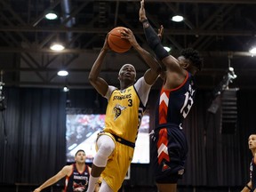 Edmonton Stingers' Mamadou Gueye (left) scores past Fraser Valley Bandits' Jamal Ray during a CEBL game at Northlands Expo Centre in Edmonton, on Thursday, Aug. 1, 2019.