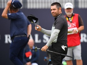 South Africa's Louis Oosthuizen reacts on the 18th green after his first-round 64 on day one of The 149th British Open Golf Championship at Royal St George's.