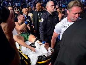 Conor McGregor is carried off a stretcher following an injury suffered against Dustin Poirier during UFC 264 at T-Mobile Arena in Las Vegas, Nevada, July 10, 2021.