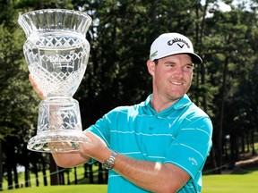 Grayson Murray of the United States celebrates with the trophy after winning on the 18th green during the final round of the Barbasol Championship at the Robert Trent Jones Golf Trail at Grand National on July 23, 2017 in Auburn, Ala.