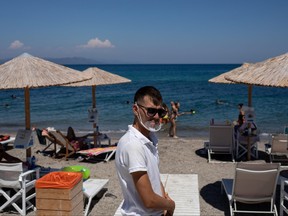 A waiter wears a protective face shield at a beach bar, following the COVID-19 outbreak, on the island of Kos, Greece, June 29, 2020.