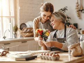 happy mother's day! family old grandmother mother-in-law and daughter-in-law daughter congratulate on holiday, give flowers