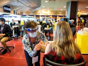 A health-care worker administers the Pfizer/BioNTech coronavirus disease (COVID-19) vaccine at Woodbine Racetrack pop-up vaccine clinic in Toronto May 5, 2021.