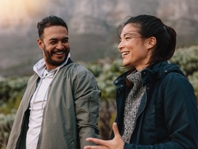 Happy couple walking and talking in the countryside