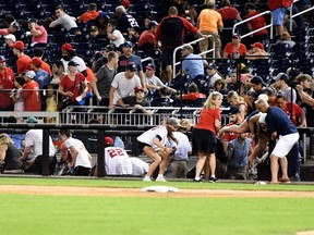 Fans run for cover after what was believed to be shots were heard during a baseball game between the San Diego Padres the Washington Nationals at Nationals Park in Washington, D.C., Saturday, July 17, 2021.