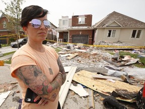 A tornado tore through a neighbourhood in the southeast end of Barrie on Thursday damaging at least 150 homes. Natalie Harris is seen here outside her ex-husband's home on Majesty Blvd., where she managed to hide in the home's basement with her son and two dogs just before the tornado hit, on Friday July 16, 2021.