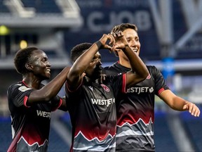 Cavalry FC's Ahinga Selemani (centre) celebrates with teammates after scoring his second goal of the match in a 4-1 victory over Atlético Ottawa on June 30, 2021 in Winnipeg.