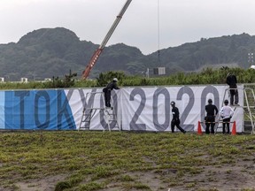 Banners are erected at the Tokyo Olympics surfing venue at Tsurigasaki Beach, in Ichinomiya, Japan, Tuesday, July 6, 2021.