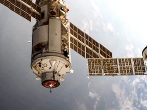 This handout photograph taken and released by the Russian Space Agency Roscosmos on July 29, 2021, shows the Russian Multipurpose Laboratory Module "Nauka" (Science) docking to the International Space Station (ISS).