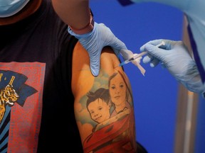 A healthcare worker administers a dose of the COVID-19 vaccine.