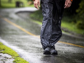 FILE: A man walks along the Rideau River Eastern Pathway in Riviera Park as Ottawa was hit with a dreary and wet day.