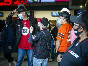 Redblacks supporters chat before Saturday's home game against the Lions.