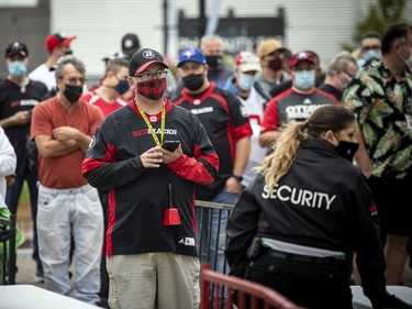 Redblacks fans enter through one of the security gates at TD Place stadium on Saturday evening.