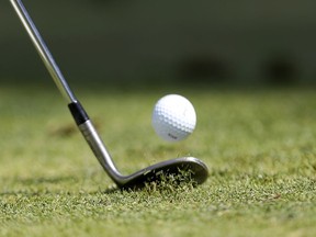 A golfer chips a ball during the final round of golf.