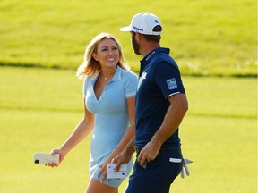 Files:  Dustin Johnson of the United States celebrates with his partner Paulina Gretzky on the 18th green after winning the FedEx Cup in the final round of the TOUR Championship at East Lake Golf Club on September 07, 2020 in Atlanta, Georgia.
