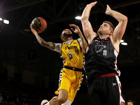 Edmonton Stingers' Xavier Moon battles Ottawa BlackJacks' Chad Posthumus during the second half of CEBL semifinal basketball action at Edmonton Expo Centre in Edmonton, on Friday, Aug. 20, 2021.