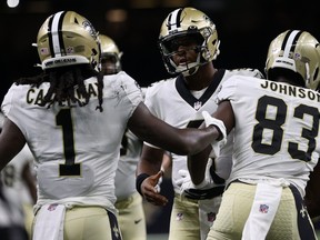 New Orleans Saints' Marquez Callaway (left) celebrates after a touchdown with Jameis Winston (centre) during Monday's game.