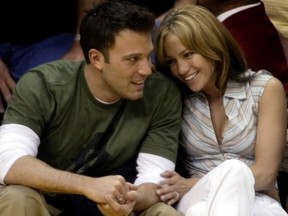 Ben Affleck gets a smile from girlfriend Jennifer Lopez during the Los Angeles Lakers and San Antonio Spurs playoff game in Los Angeles, May 11, 2003.