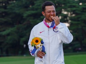 Gold medallist USA's Xander Schauffele holds his medal at the medal ceremony of the mens golf individual stroke play during the Tokyo 2020 Olympic Games.