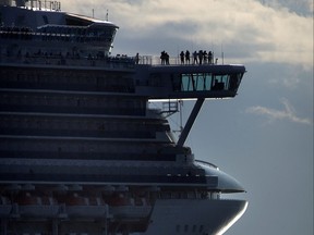 Cruise ship Diamond Princess passes by a small boat as it heads out to sea from Vancouver on Aug. 30, 2008.